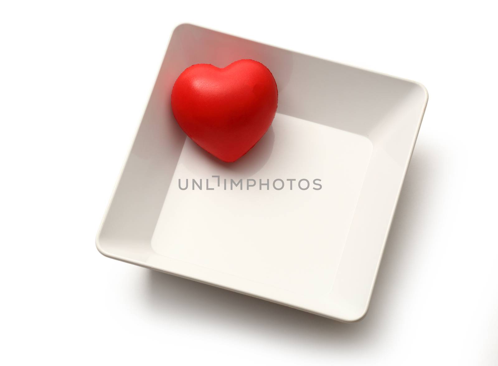 Red heart in white bowl