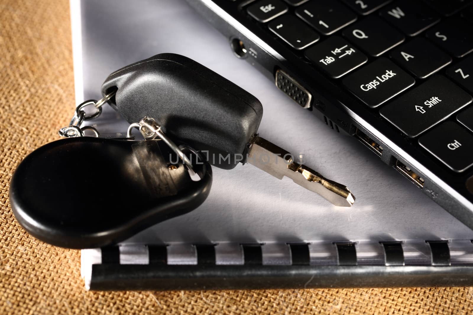 Notebook, car key and computer keyboard