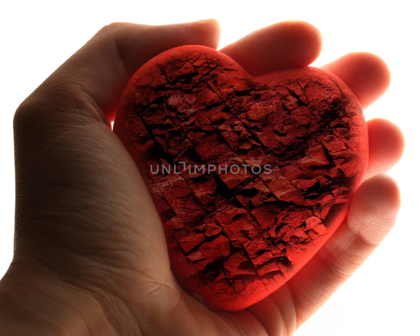 Red stone heart in male hand