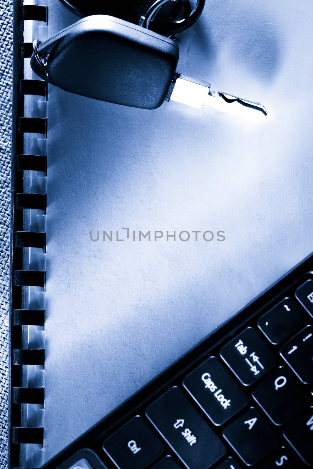 Notebook, car key and computer keyboard by Garsya