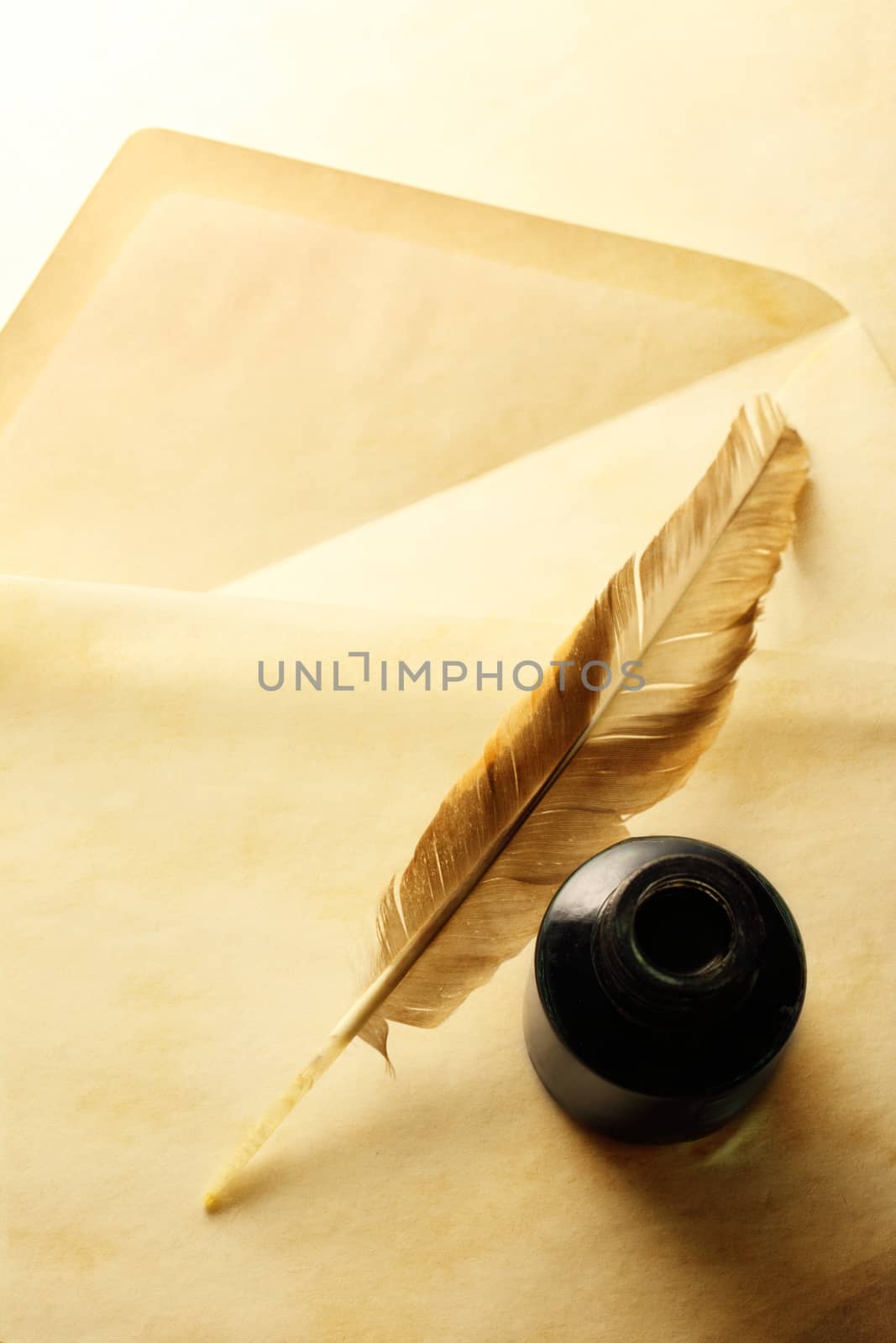 Blank envelope with inkwell and feather