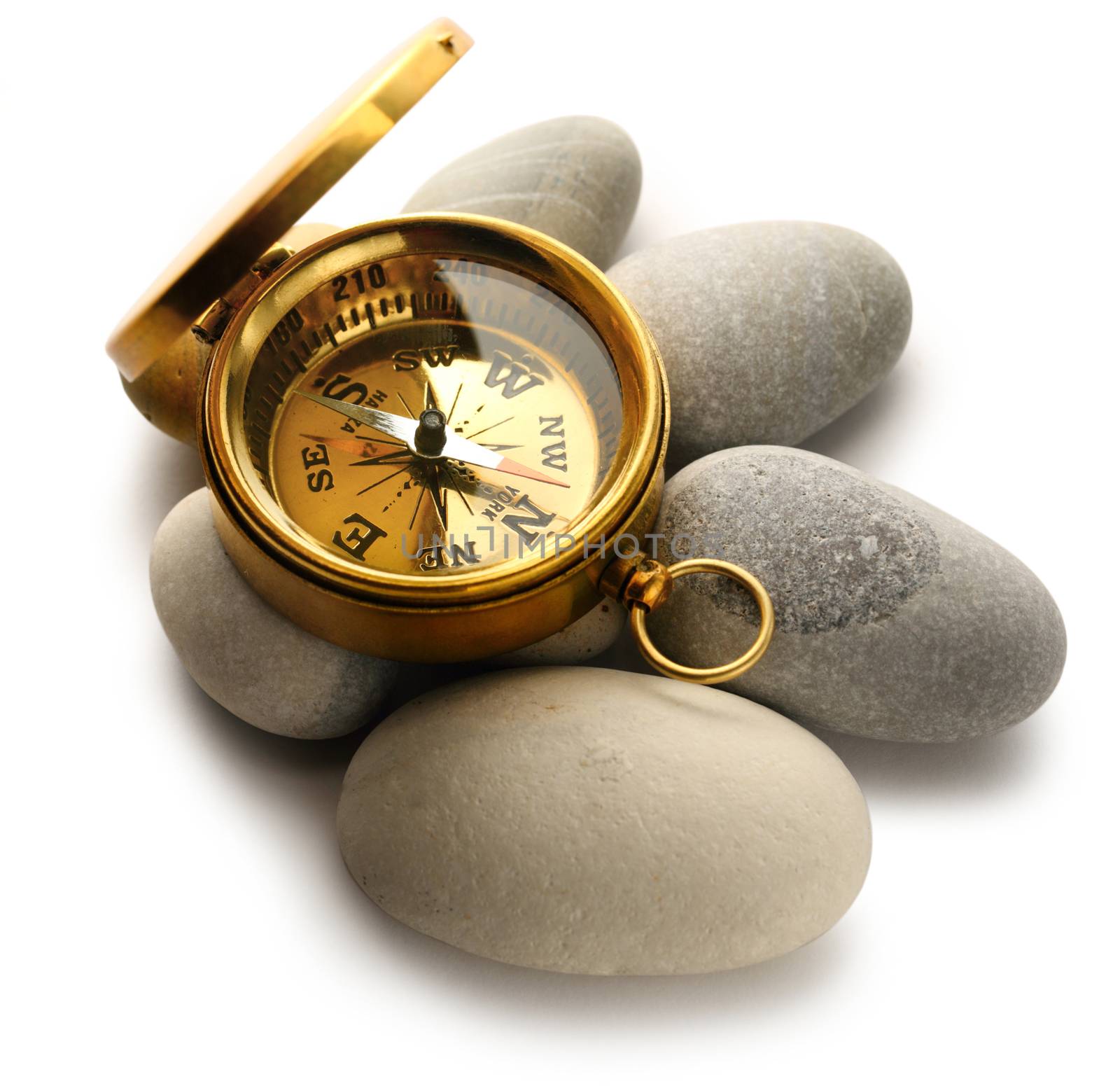Compass and sea stones on white