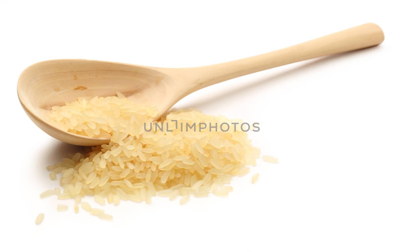 Heap of rice with wooden spoon on white