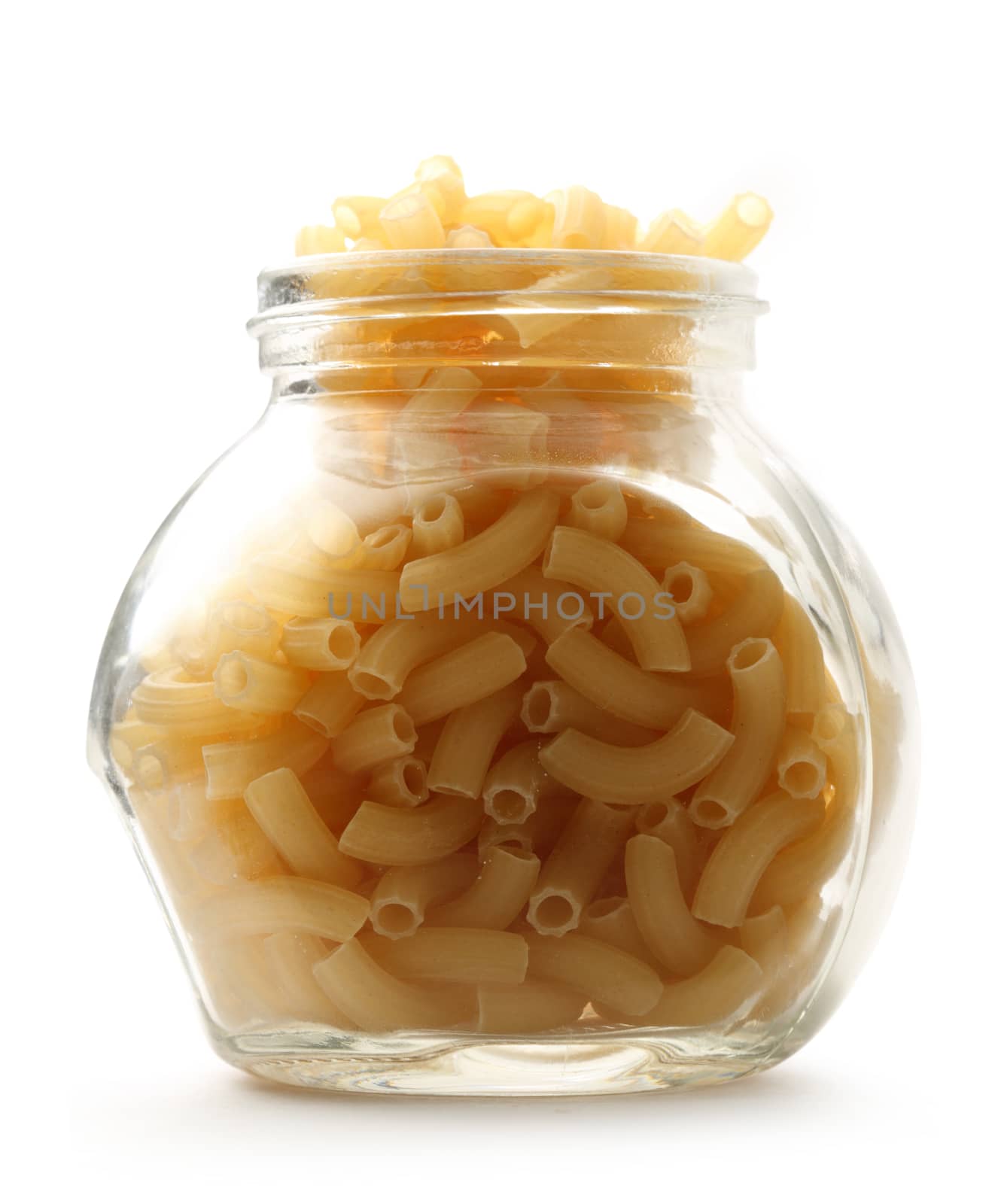 Short ribbed pasta tubes in jar on white