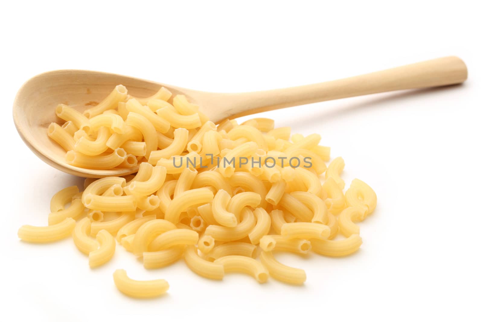 Short ribbed pasta tubes and wooden spoon