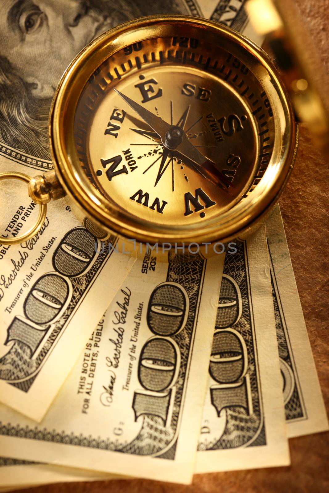 Golden vintage compass and money