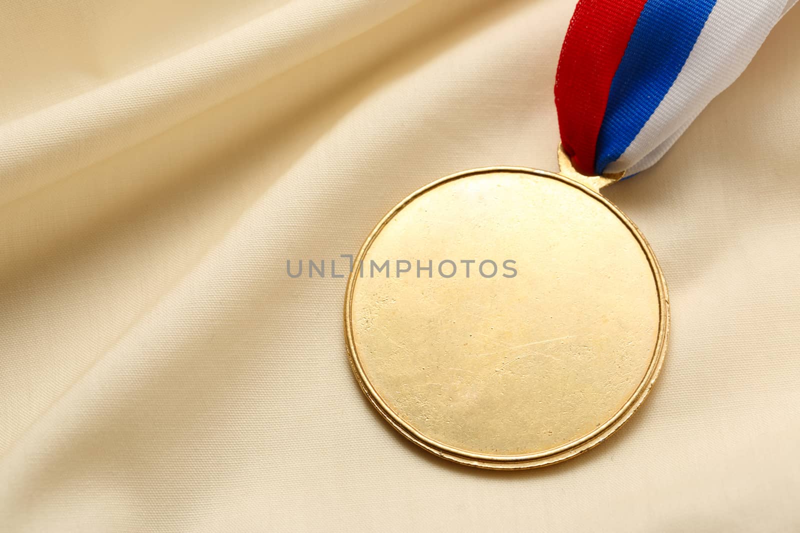 Metal medal on silk wrinkled cloth