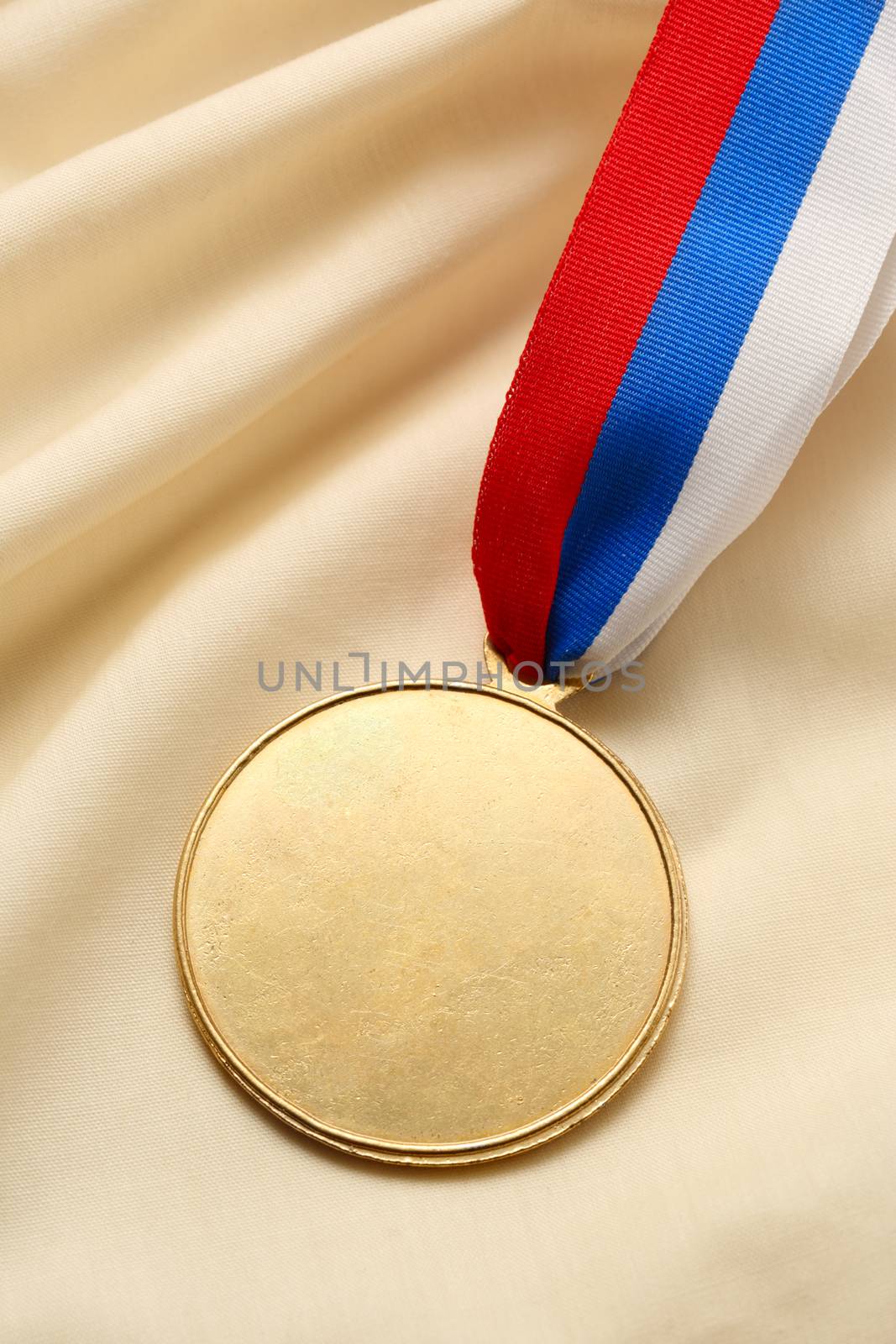 Metal medal on silk wrinkled cloth