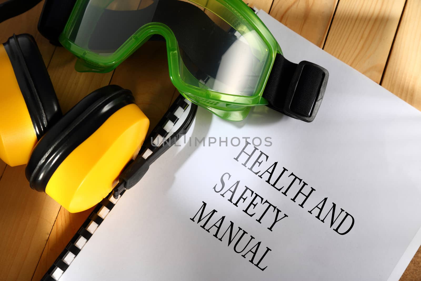 Manual with goggles and earphones on wooden background