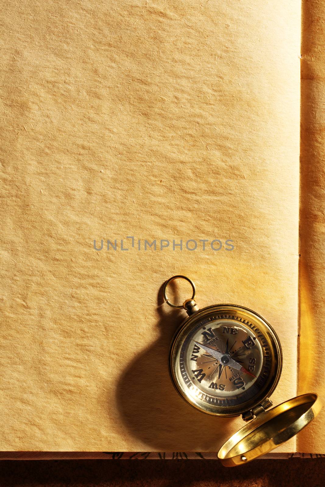 Vintage compass on blank yellowed paper by Garsya