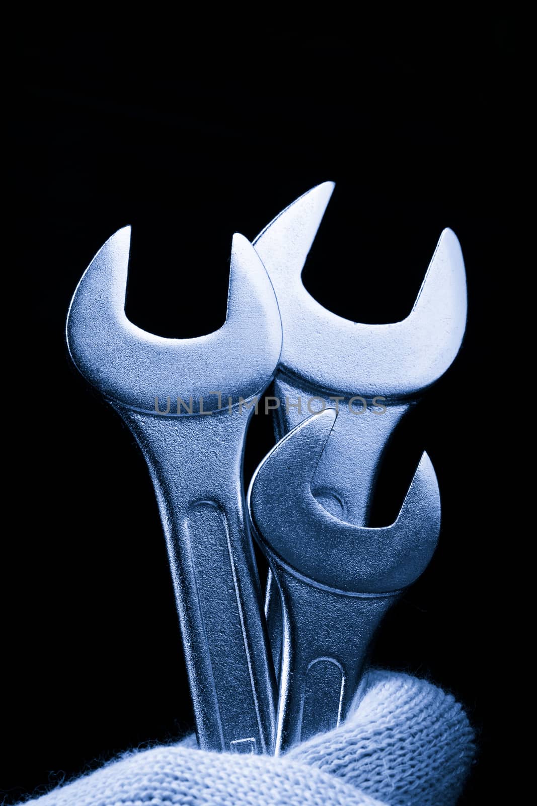 Metallic wrenches in male hand