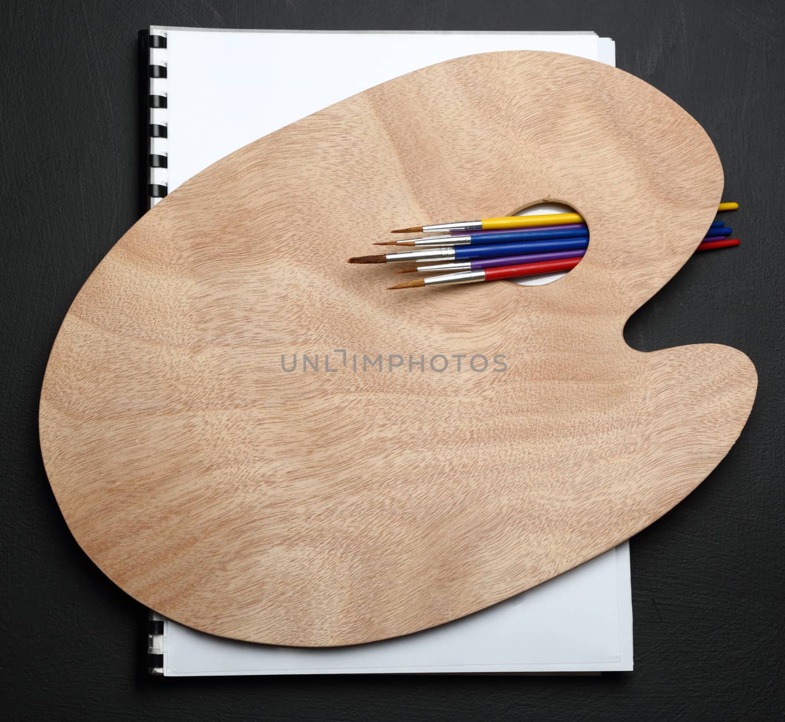 Clean wooden palette and paint brushes
