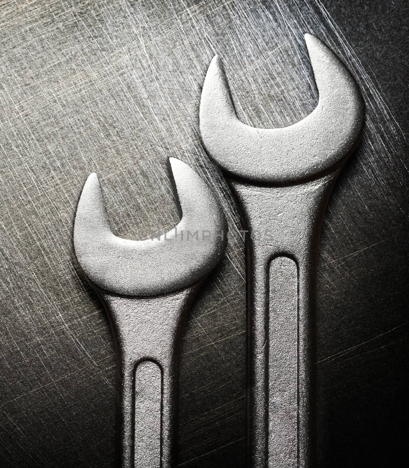Spanner on steel scratchy background