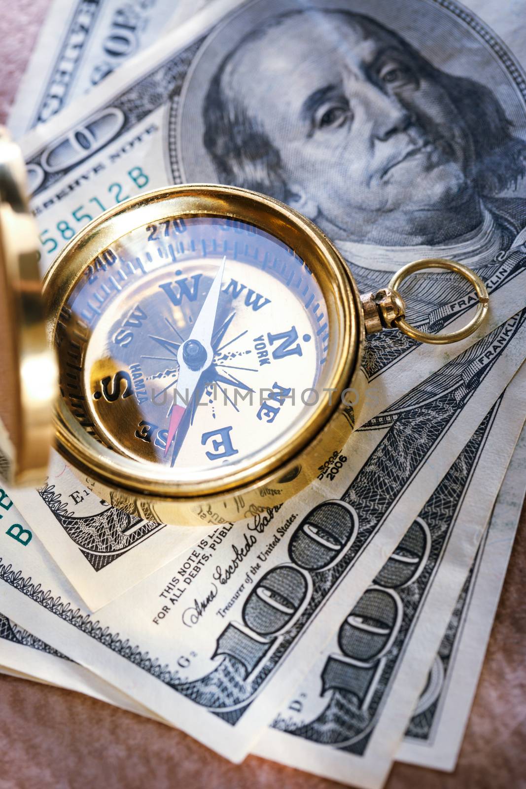 Golden vintage compass and money