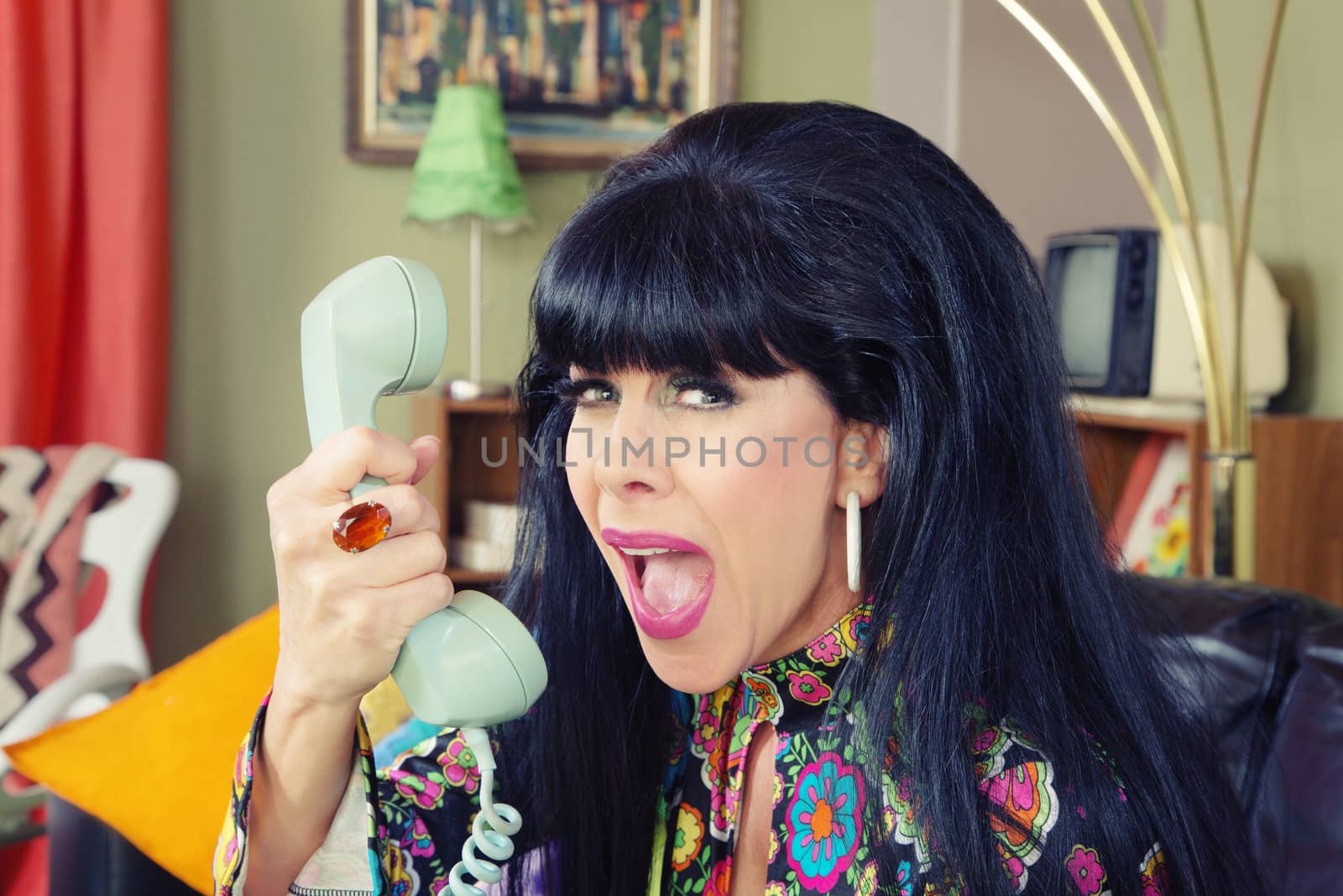 Woman yelling into phone with bad connection