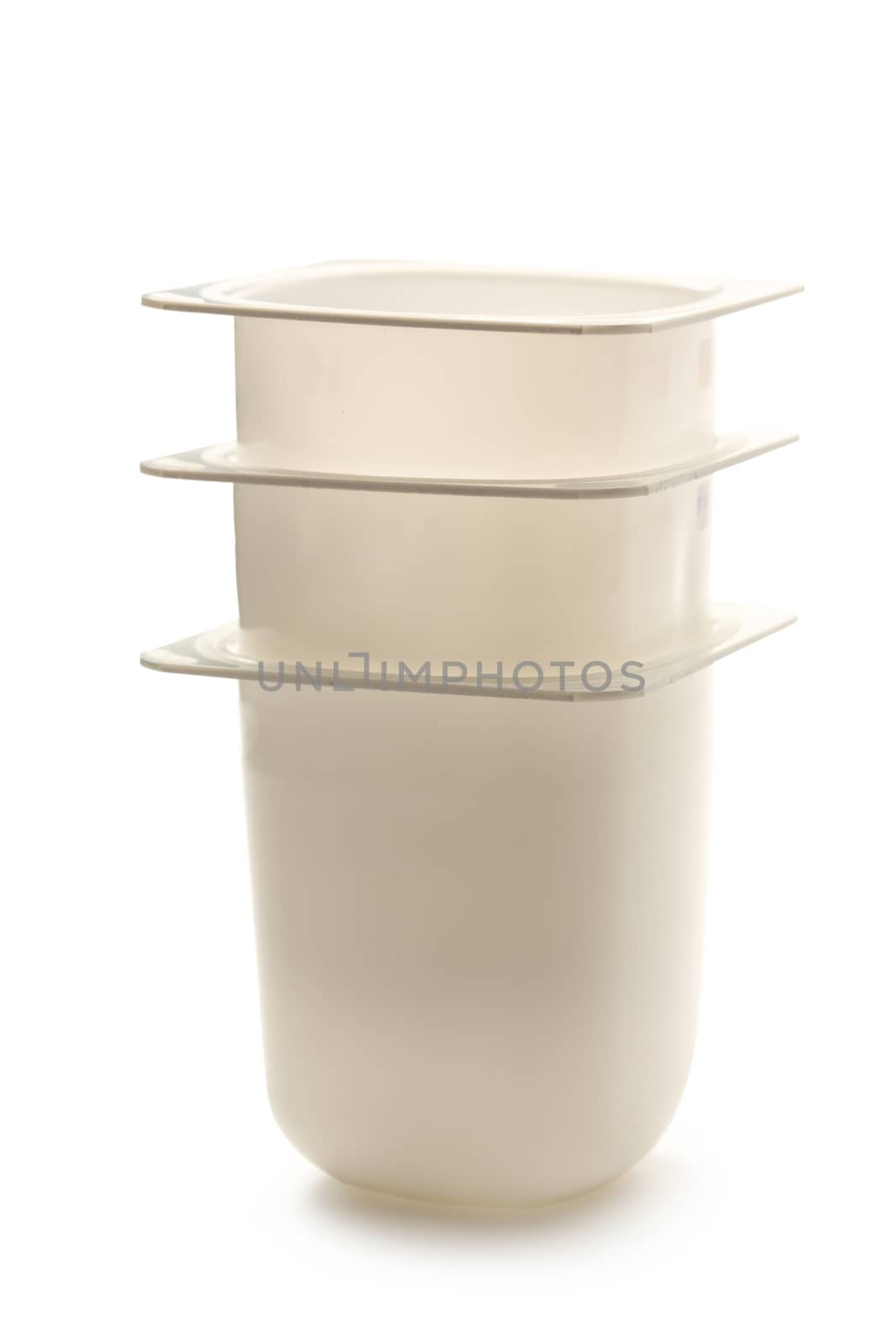 Empty plastic yogurt pots on white