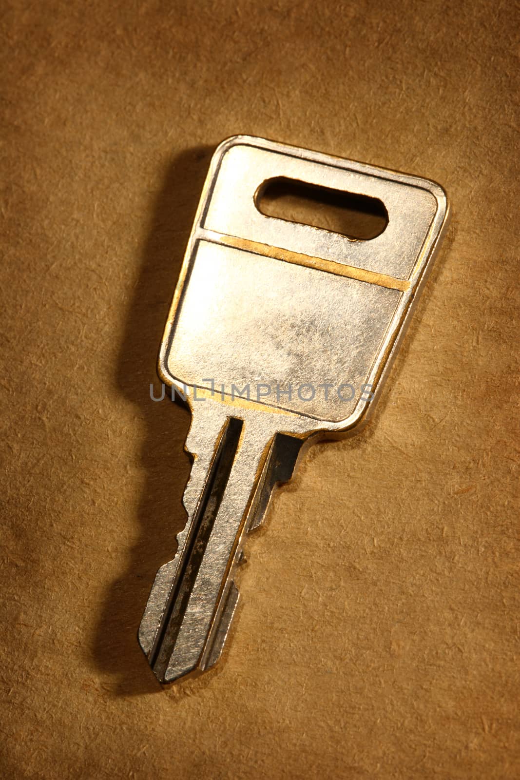 Metal key on paper background