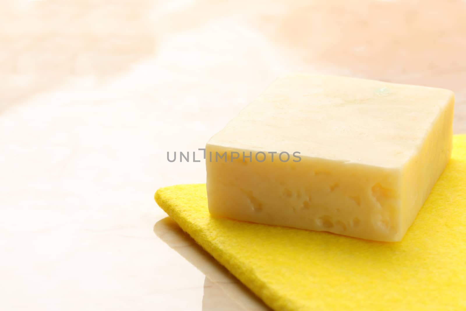 Bar of soap and duster on tile