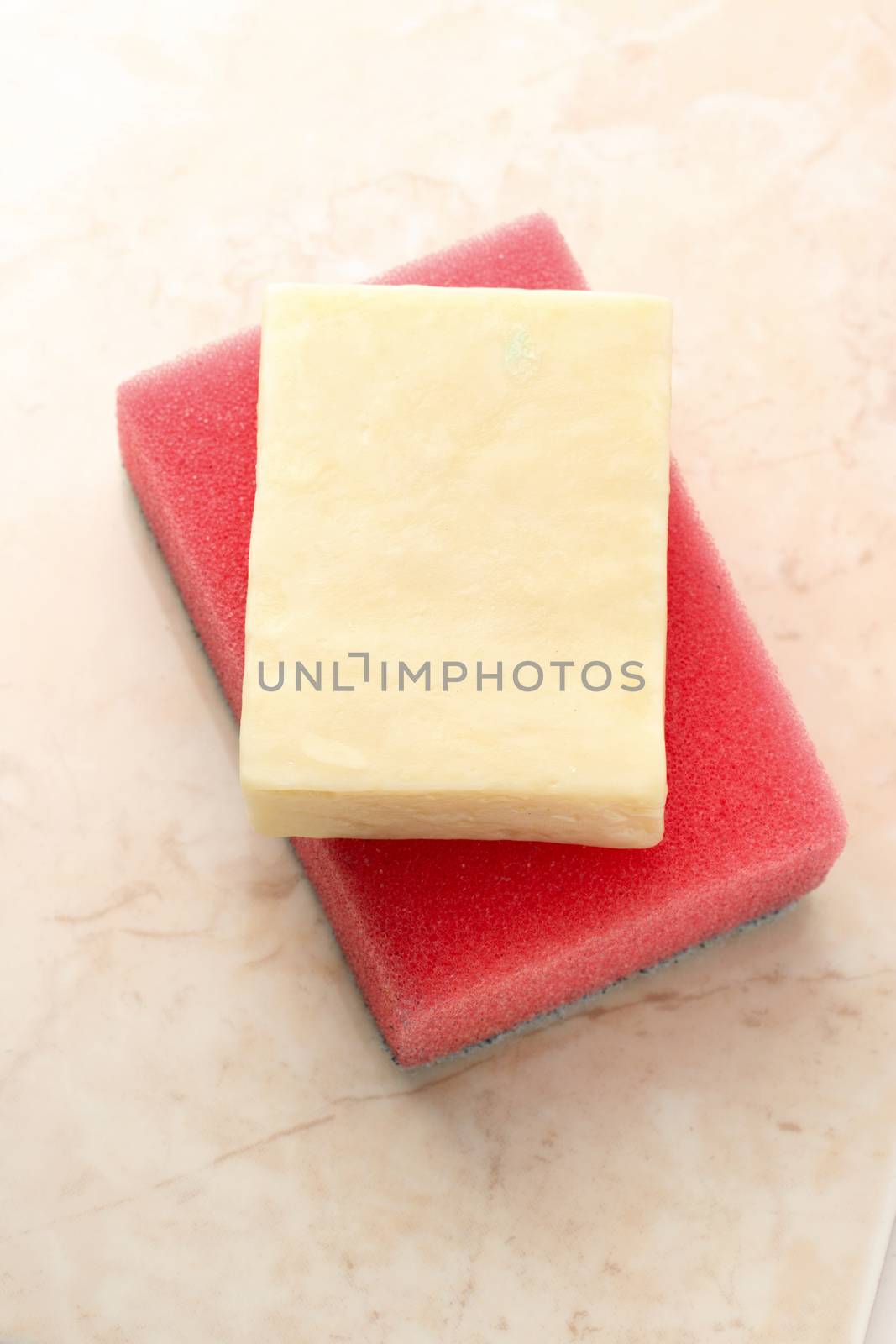 Bar of soap and sponge on tile