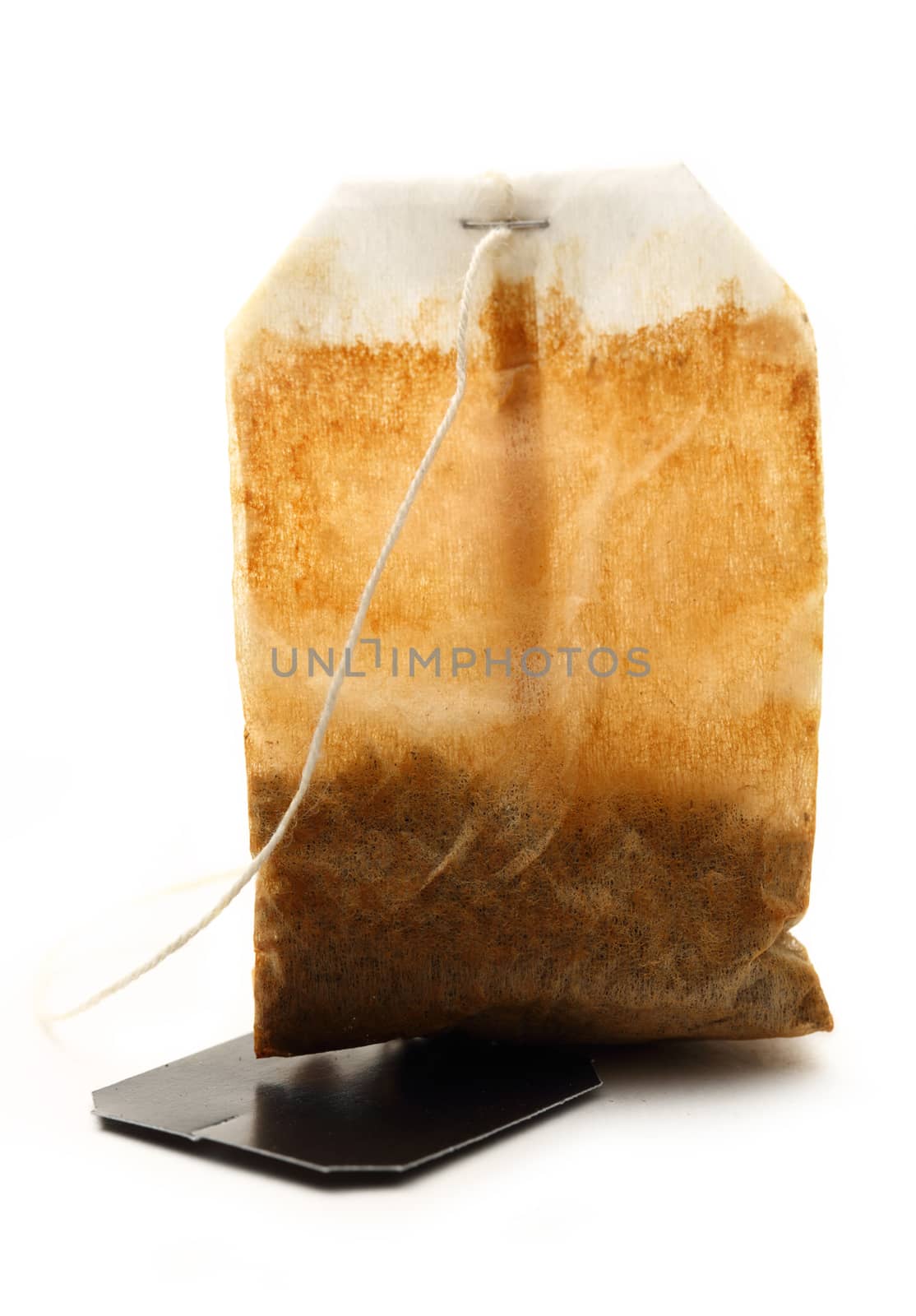 Used tea bag with label on white