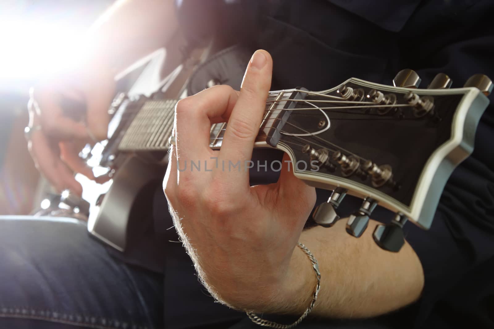 Electric guitar in male hands