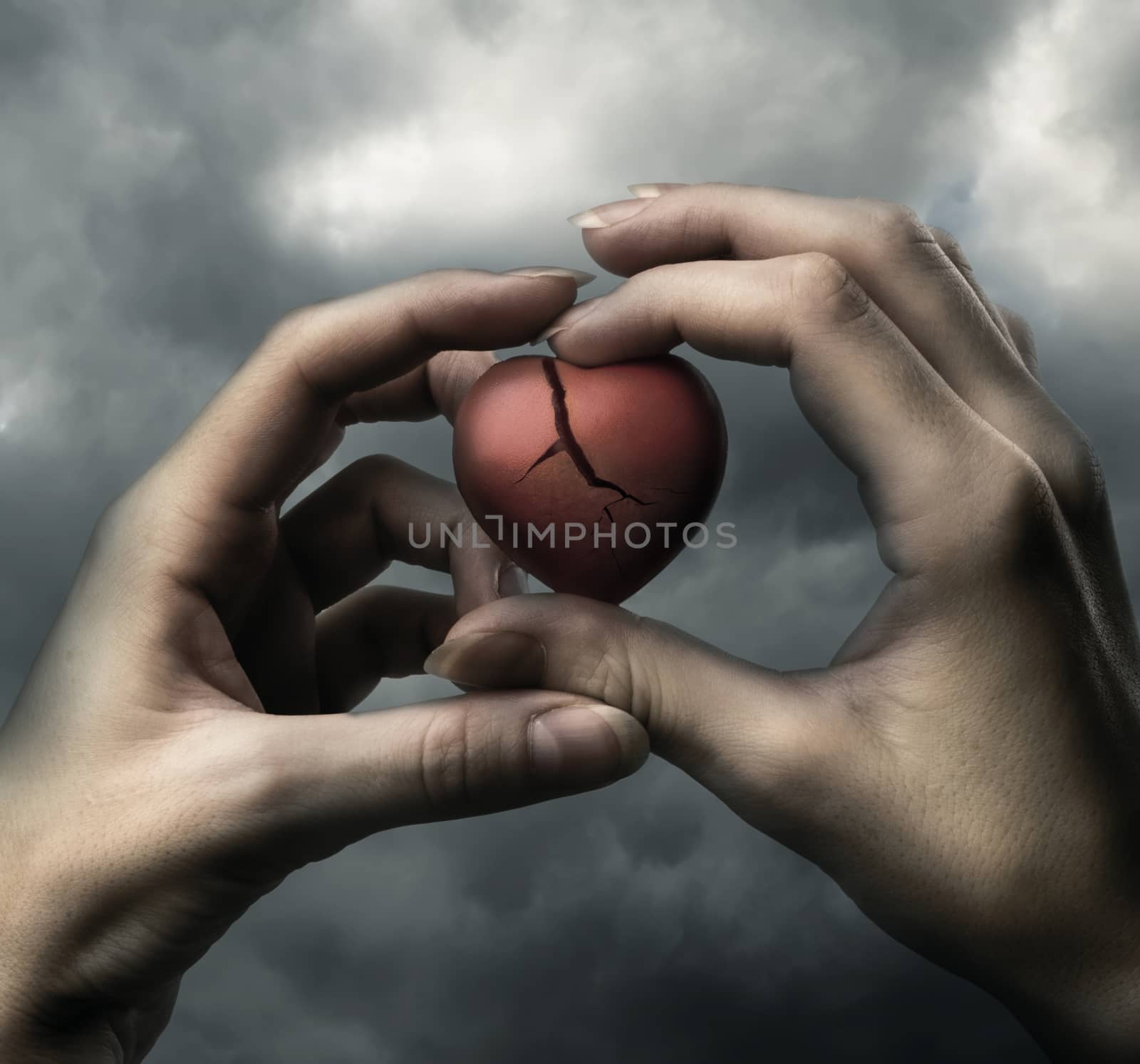 Broken red heart in hands by Garsya