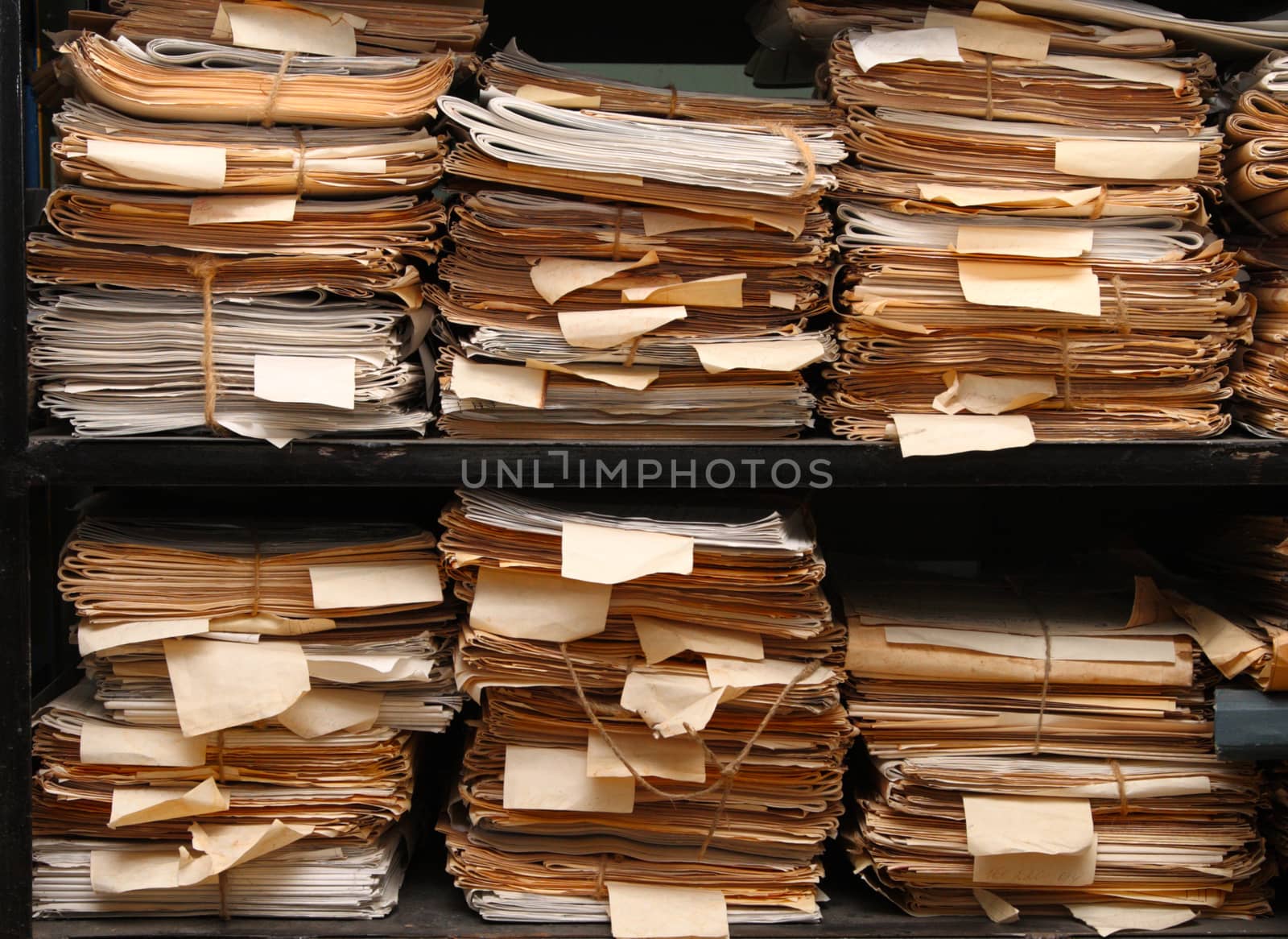 Paper documents stacked in archive