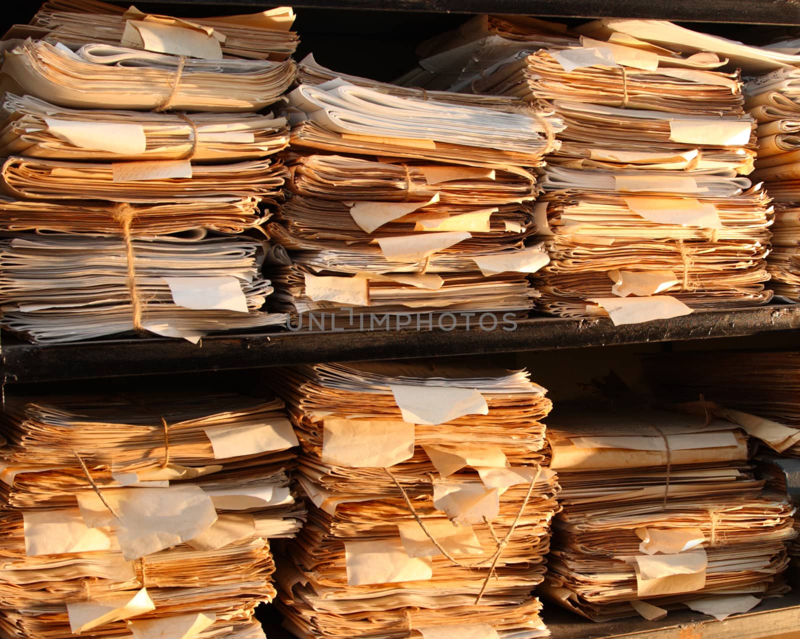 Paper documents stacked in archive