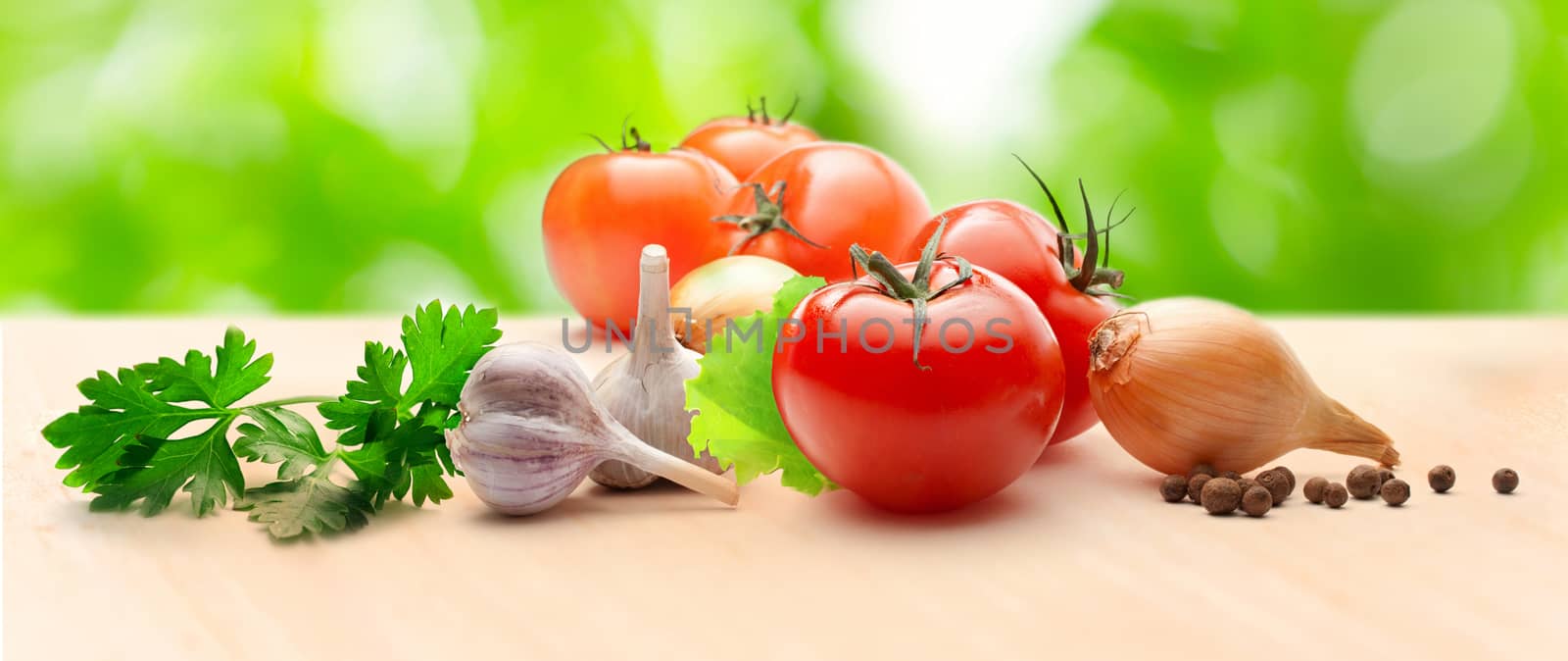 Tomatoes, onions, pepper, parsley and garlic on table