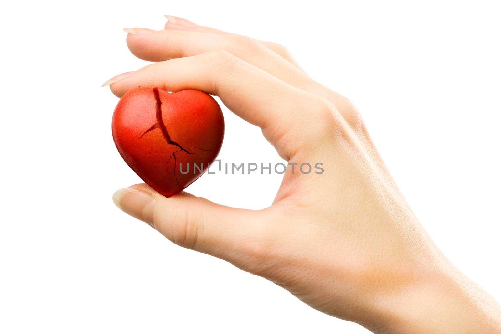 Female hand with broken red heart