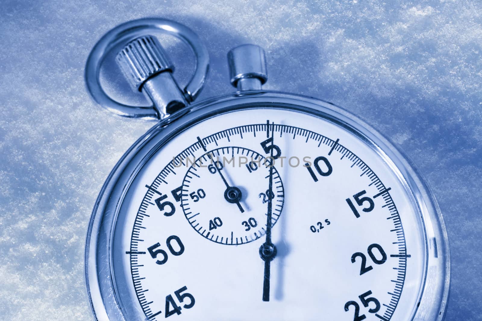 Stopwatch on snow in blue toning