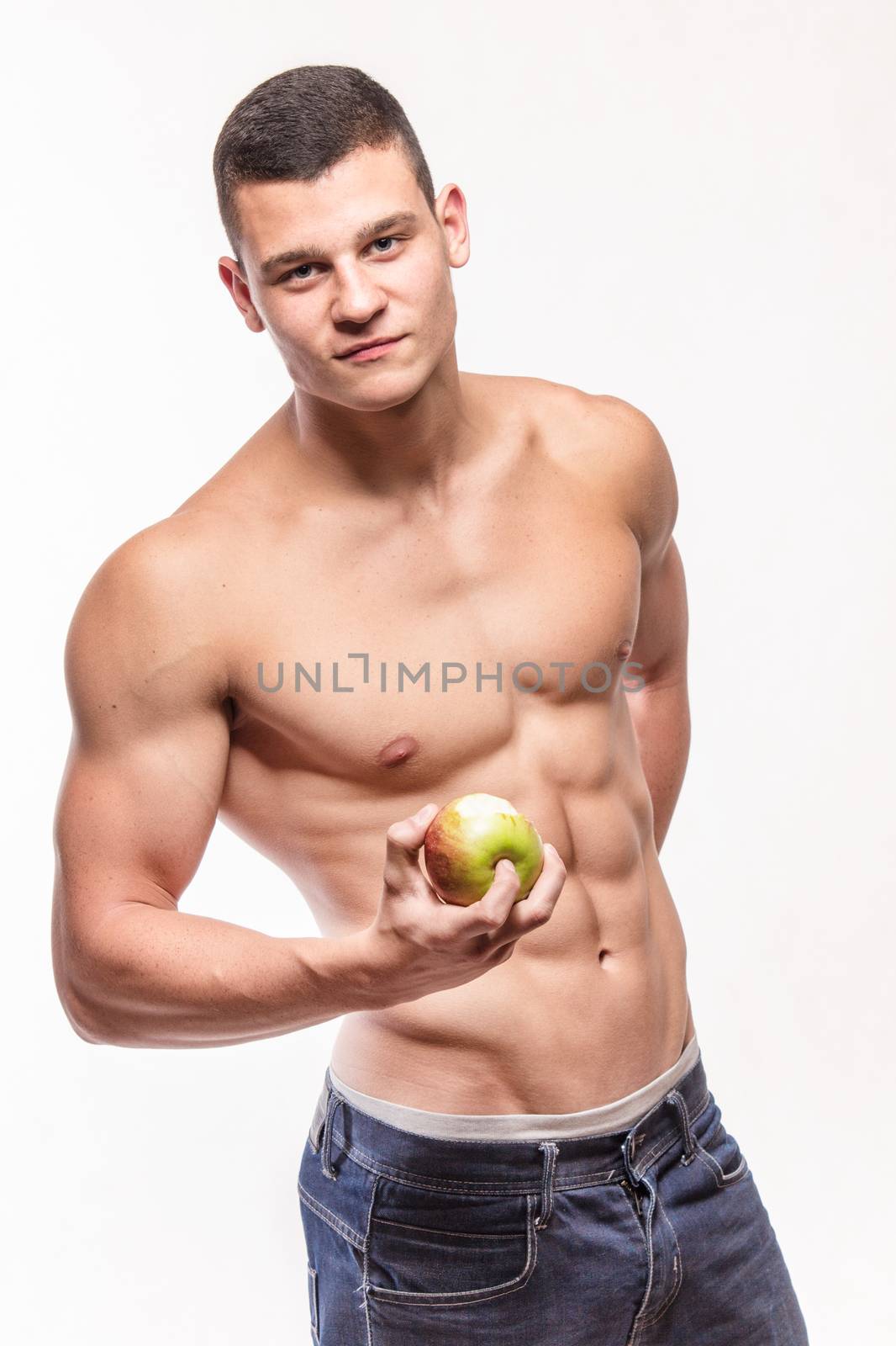 Muscular fitness man with apple - studio shoot 