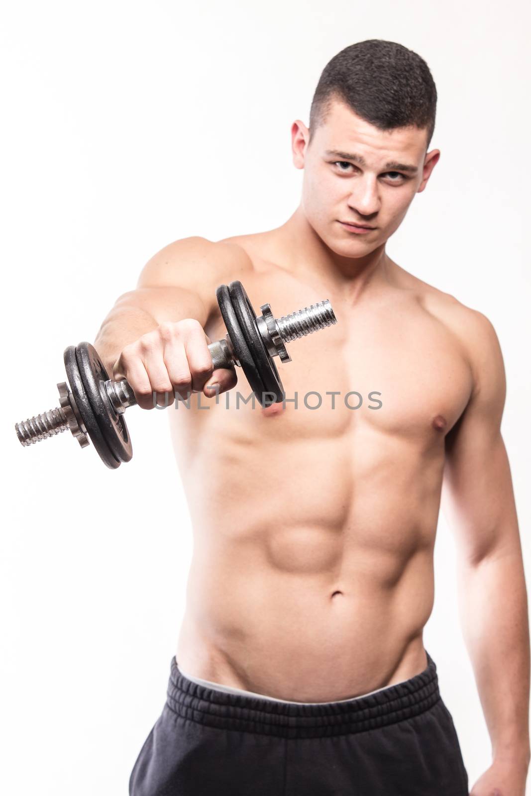 Muscular fitness man holding dumbbell - studio shoot 