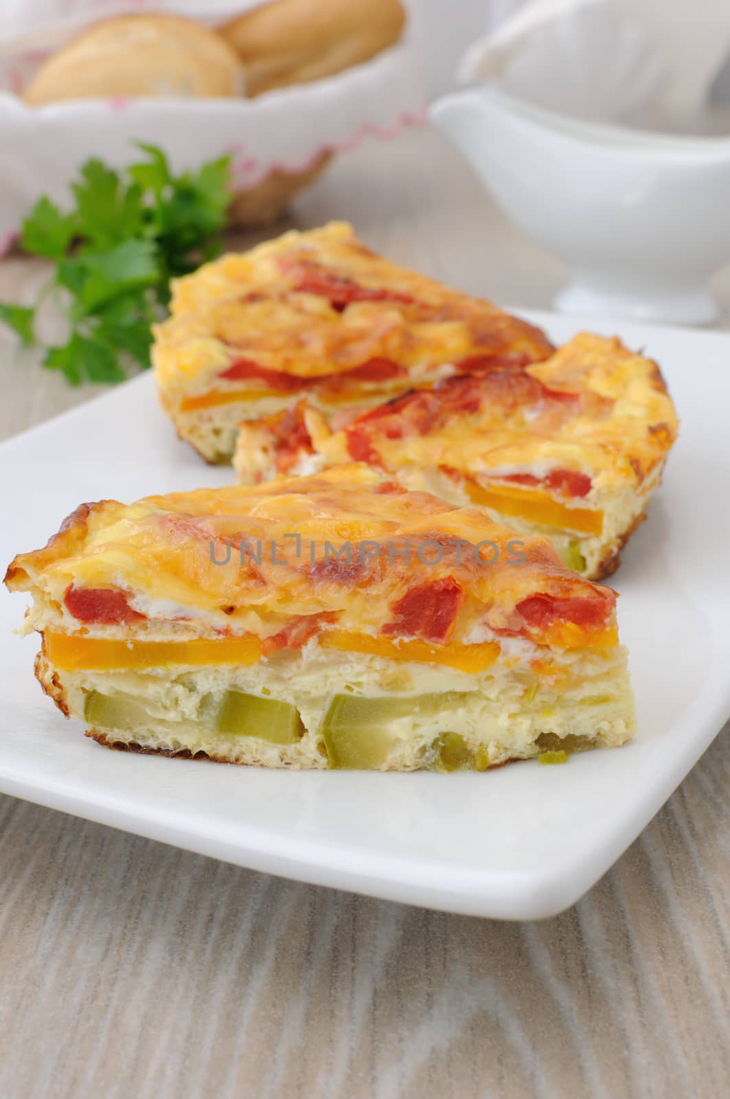 portion omelette with zucchini, carrot, tomato, cheese