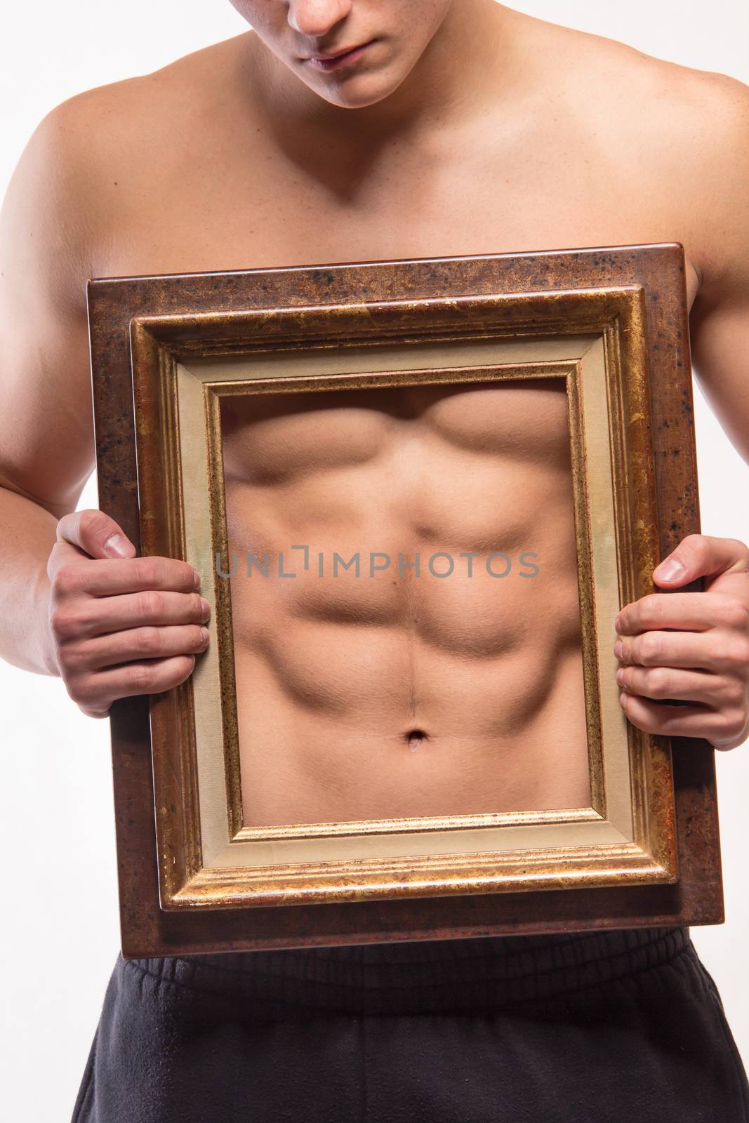 Muscular man with six-pack and frame on his torso - studio shoot