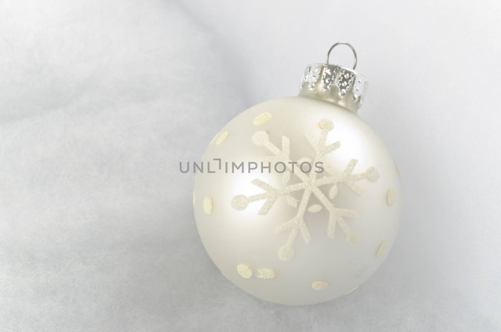 Christmas Bauble on snow white background