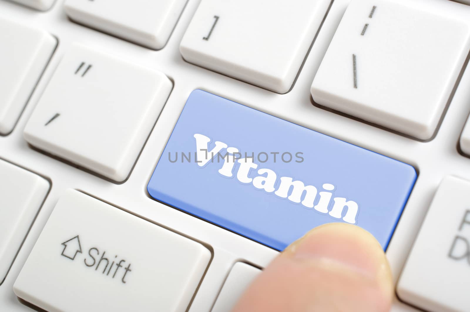 Pressing blue vitamin key on keyboard 