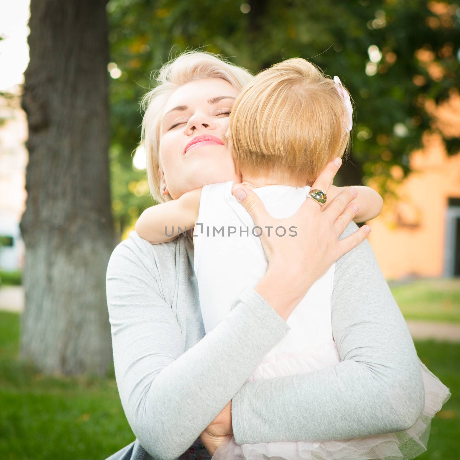 happy mother holding her 2 years old child