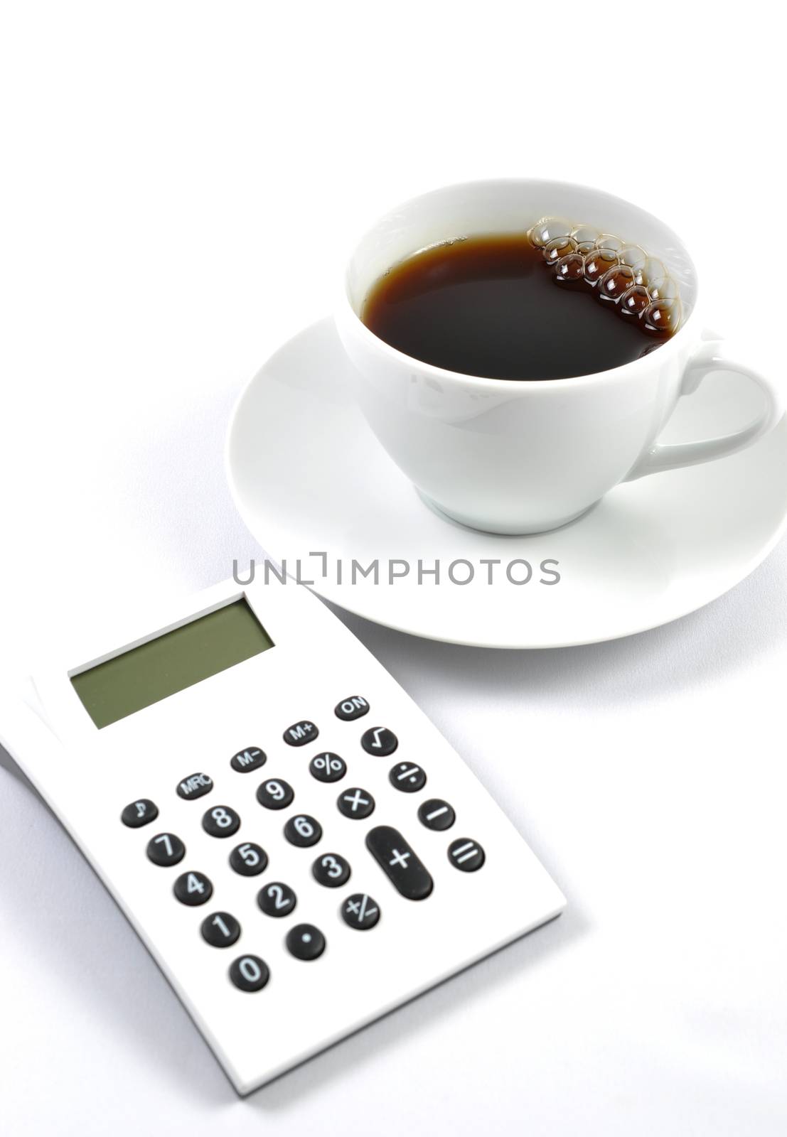 Coffee and calculator on white background