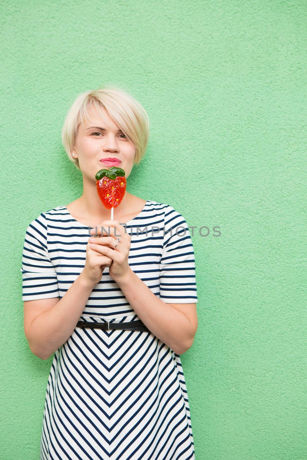 Young sexy woman sucking lollipop.  by sarymsakov