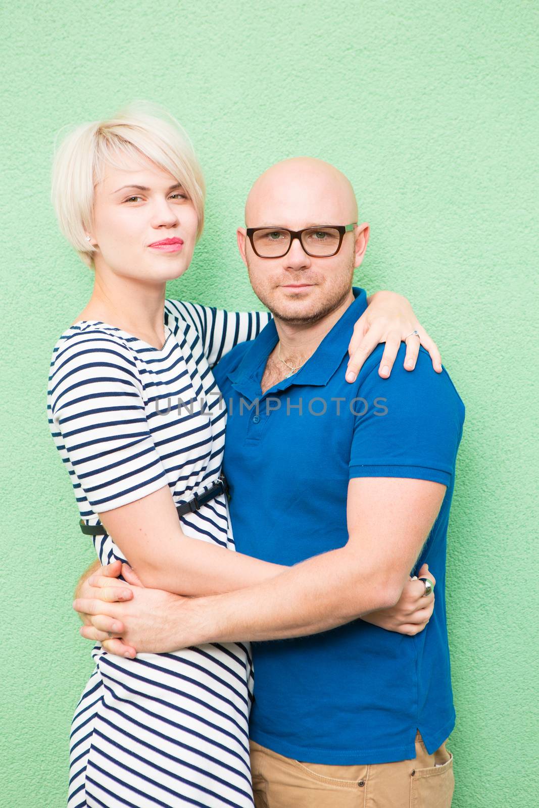 Young couple smiling, portrait. Blond woman and bald man