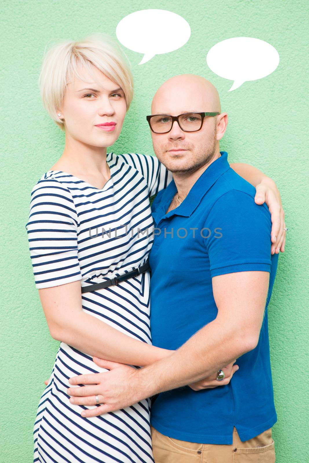 Young couple smiling, portrait. Blond woman and bald man