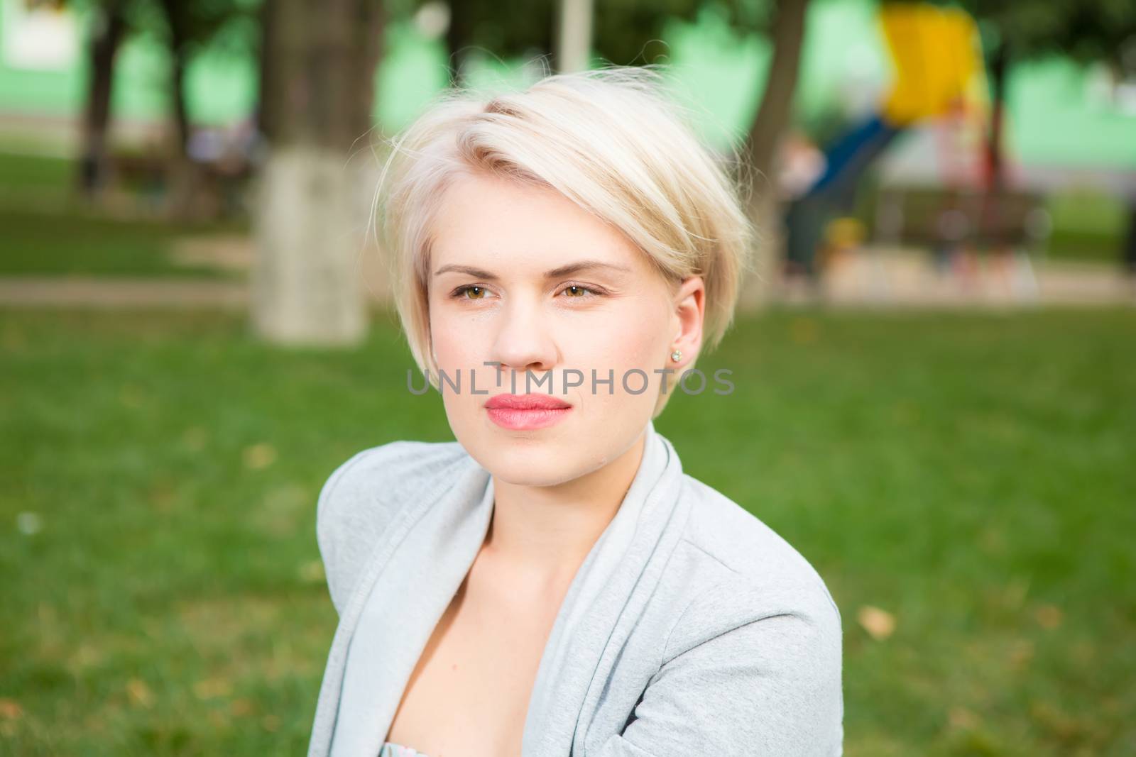 portrait of a beautiful blonde outdoors in the park