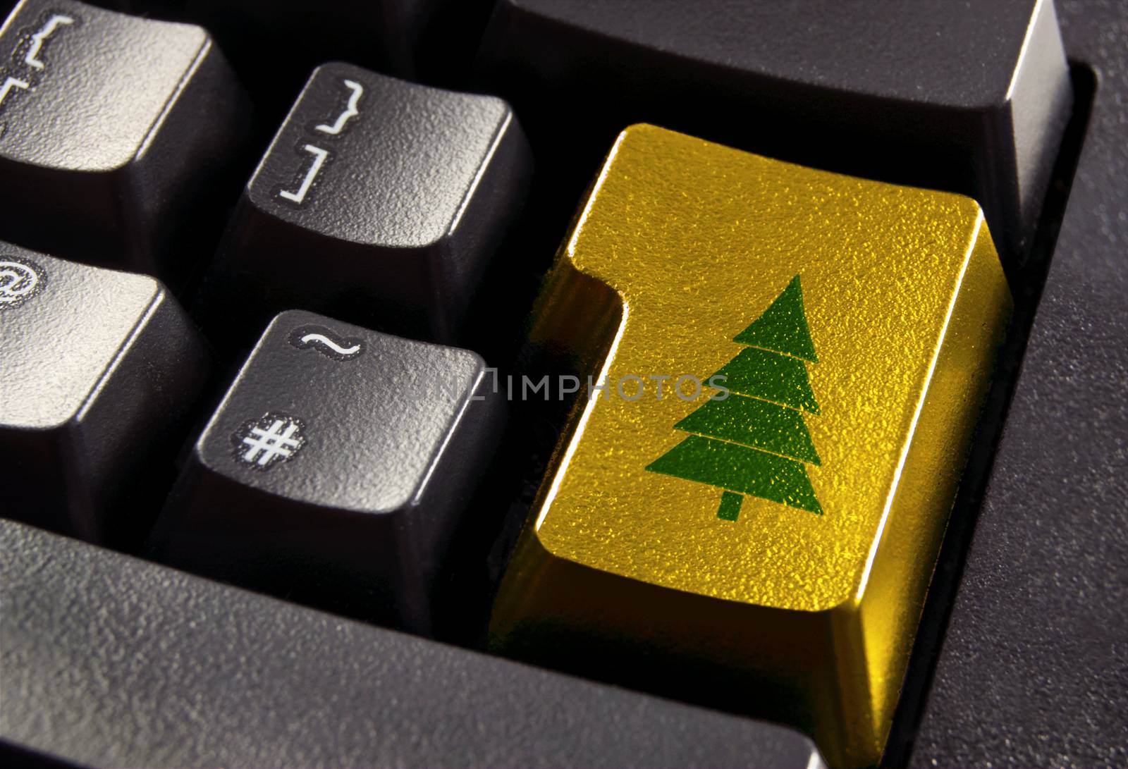 Gold computer enter key with green christmas tree symbol