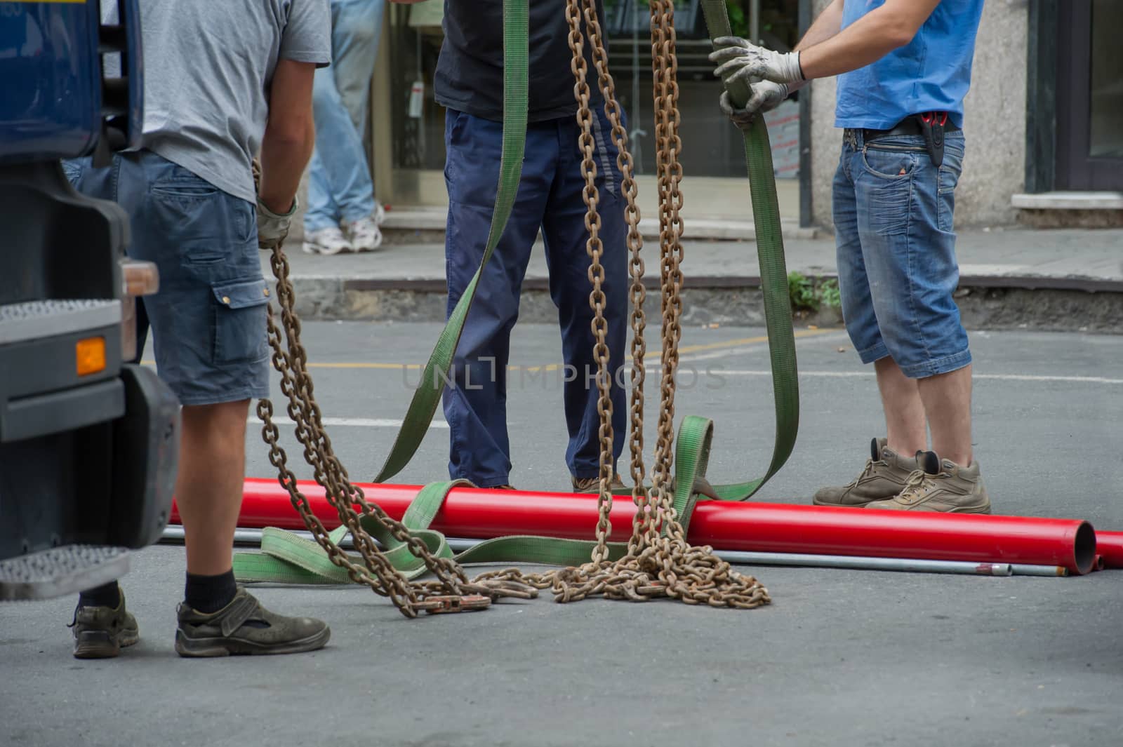 A working group is preparing to lift heavy pipes