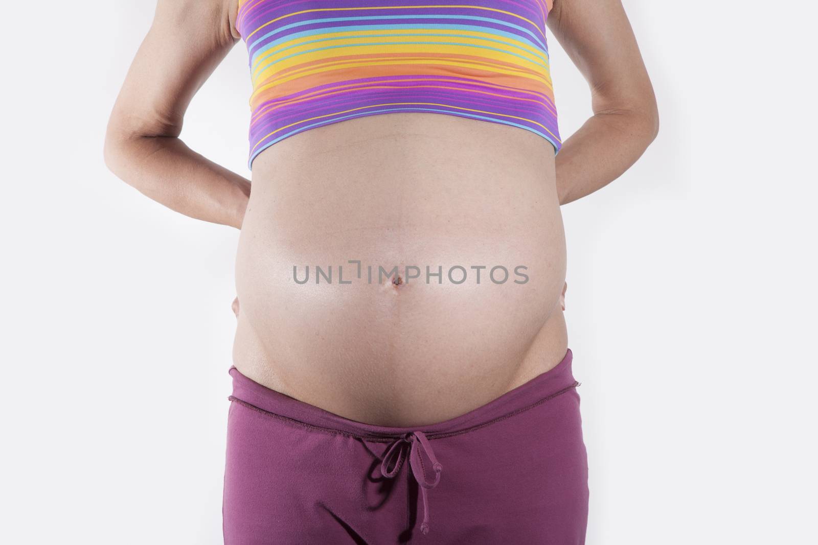 front of naked paunch pregnant woman over white background