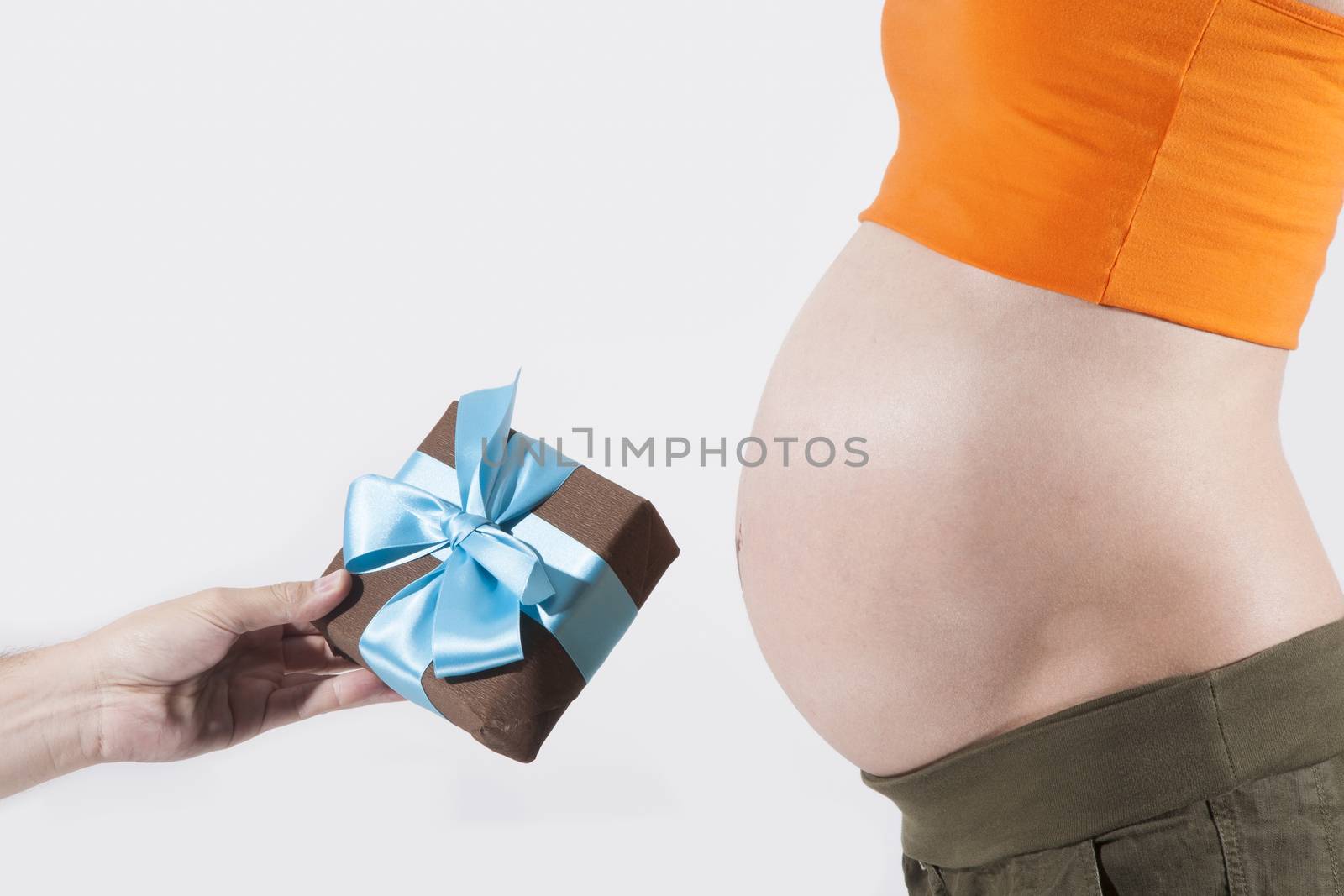 offering gift box to tummy of naked pregnant woman