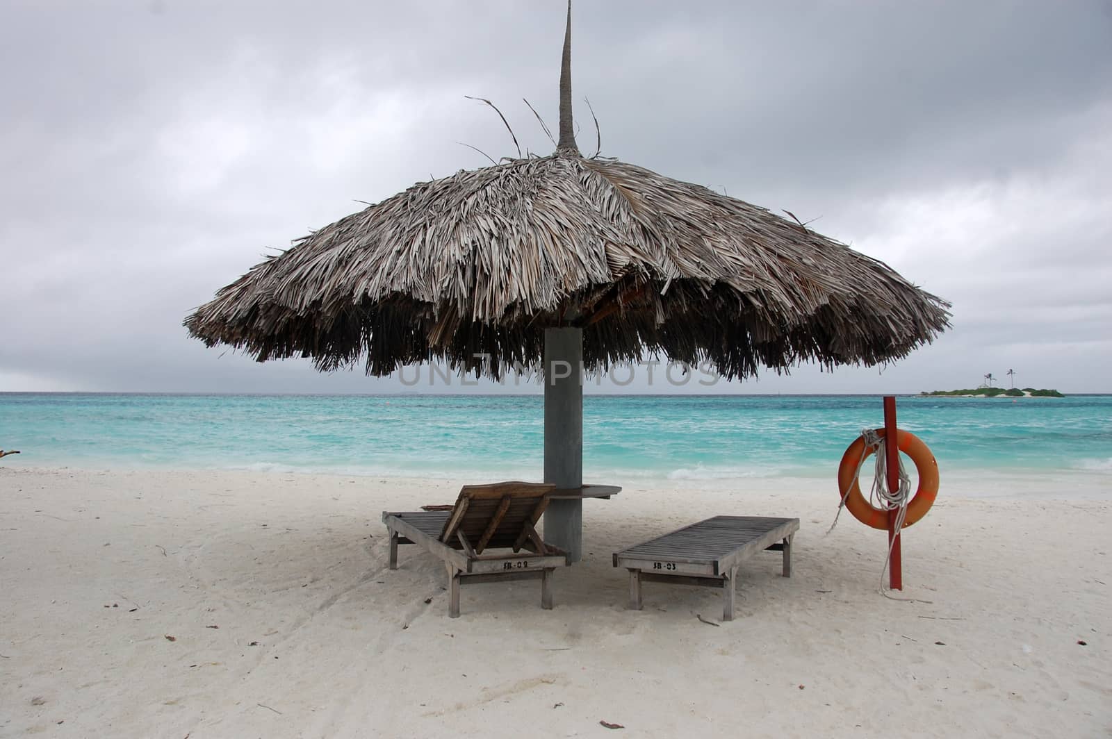 Beach umbrella and sun lounger with lifebuoy at Maldives, Paradise Island Resort