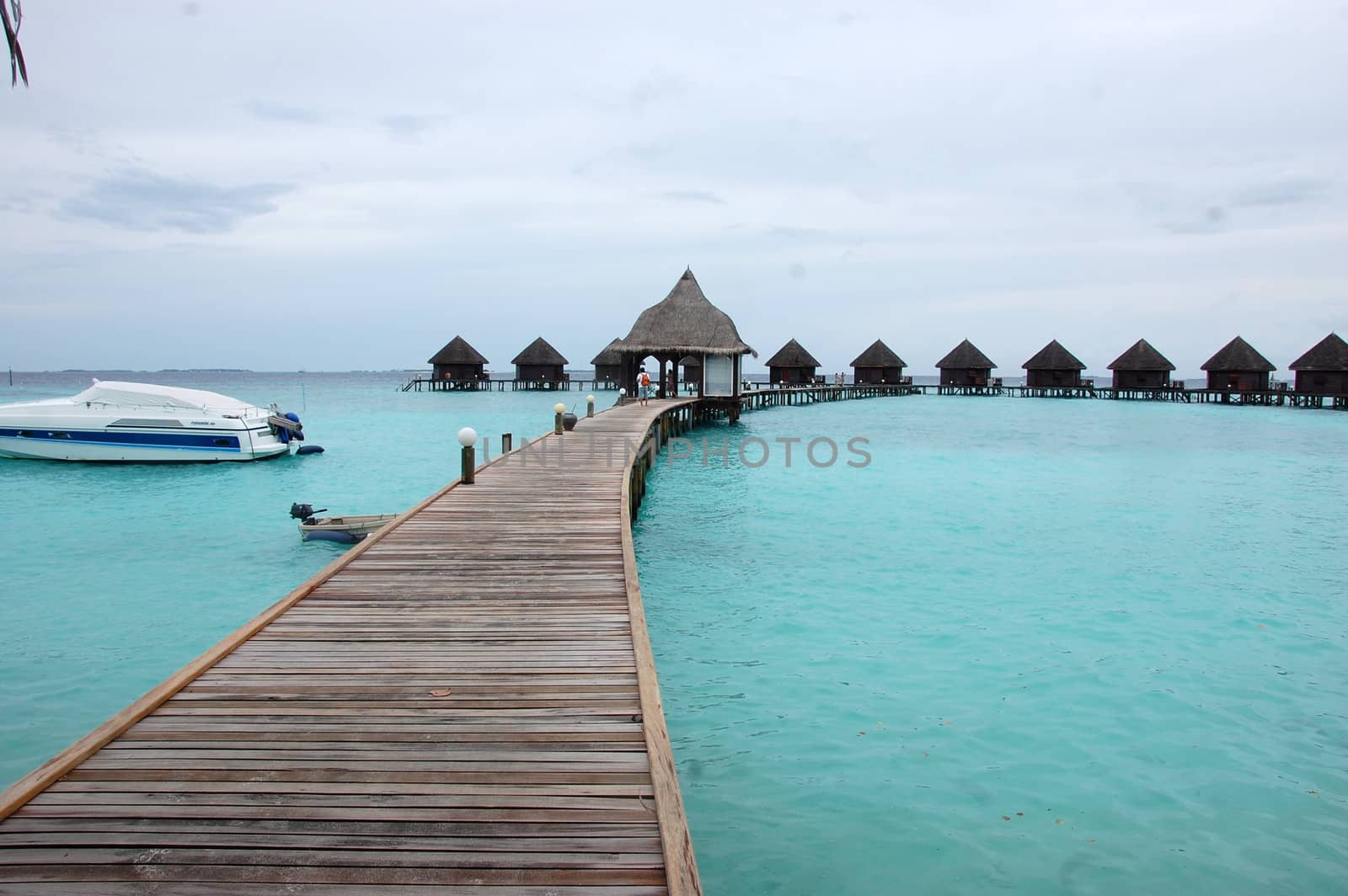 Timber pier and bungalow at Maldives by danemo