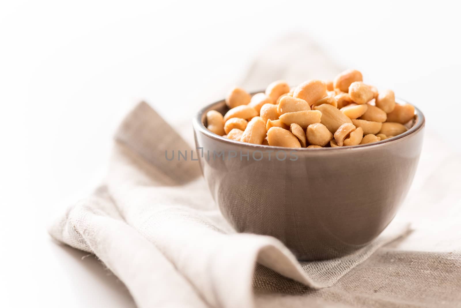 Processed peanuts in a bowl on tablecloth